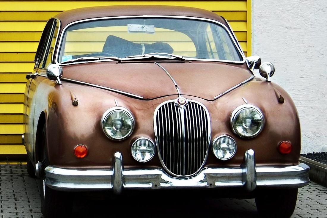 The same model of classic sedan with finished paint and chrome