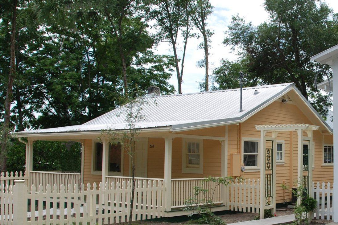 The same cottage repainted in warm peach with white trim