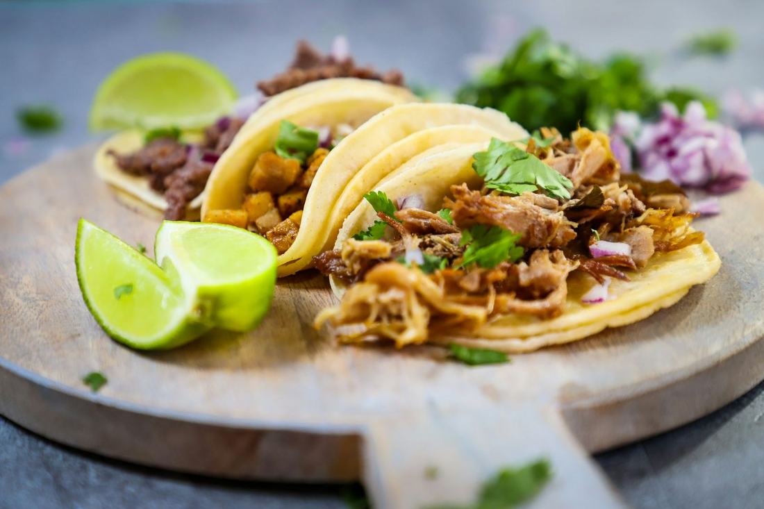 Tacos with lime wedges on a plate
