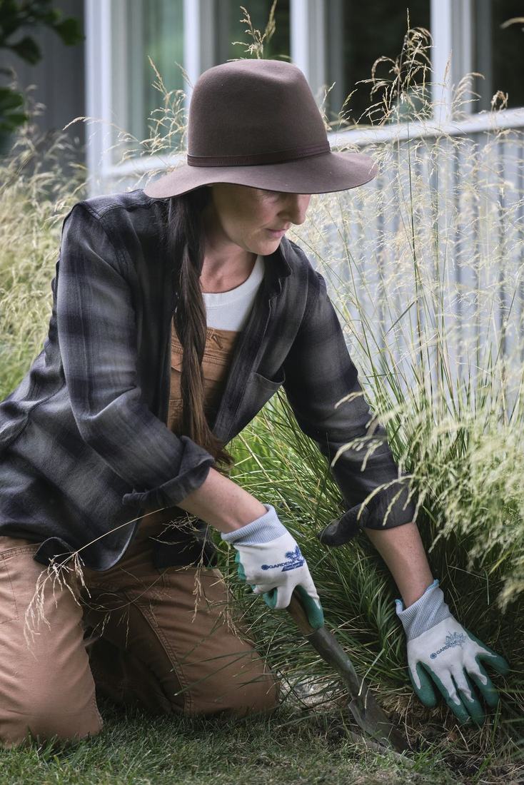 Landscaper planting ornamental grasses