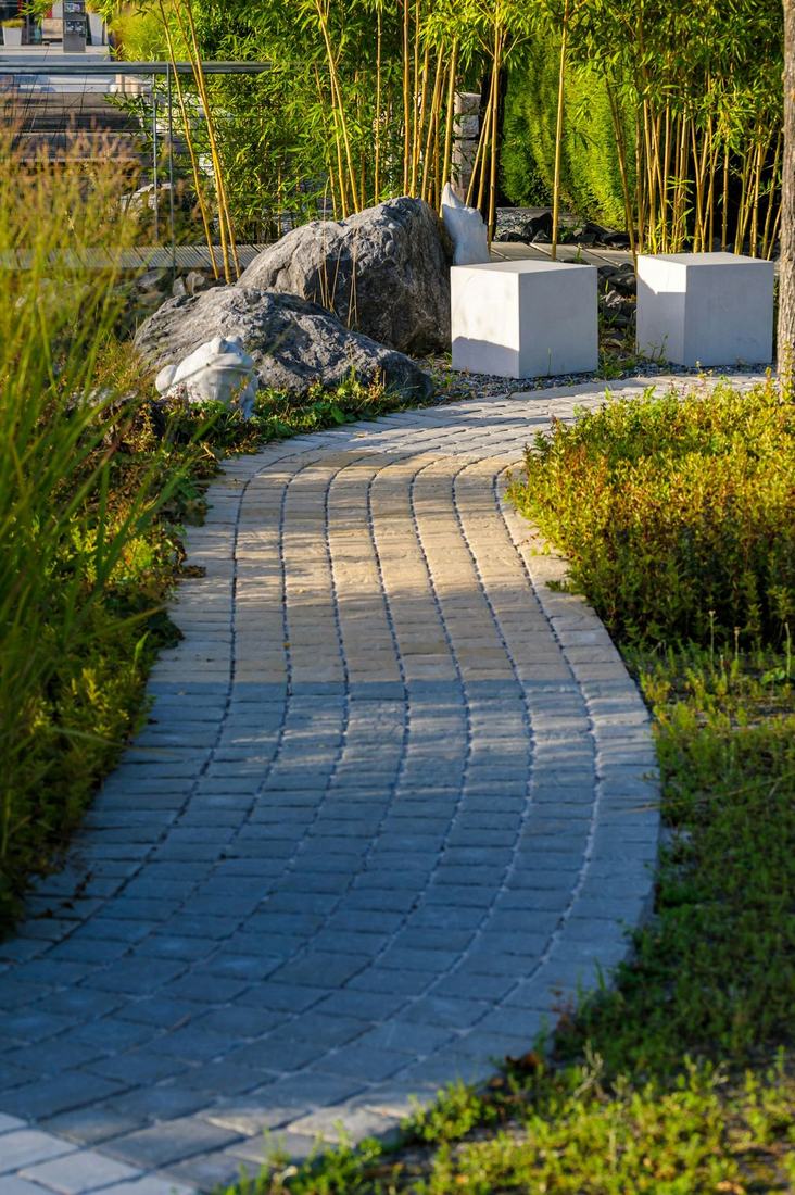 Curved paver walkway through plantings