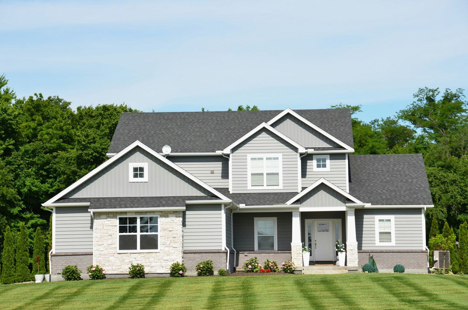 Two-story home with a landscaped yard and striped lawn