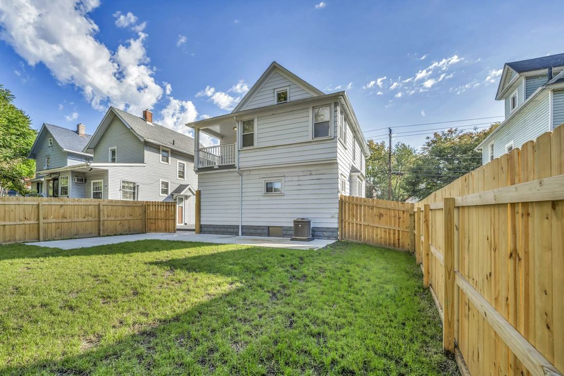 Backyard enclosed by a new wood privacy fence