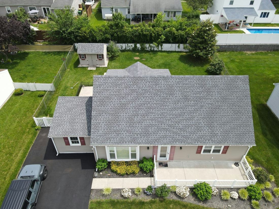 Aerial view of a home with a new gray shingle roof